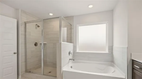 a bathroom with a bathtub and a shower