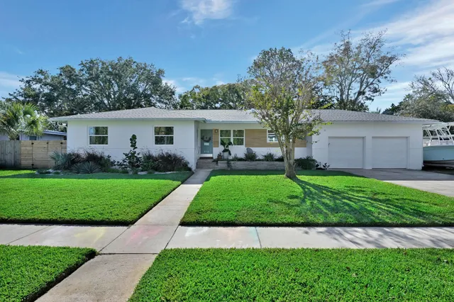 a view of a yard in front view of a house