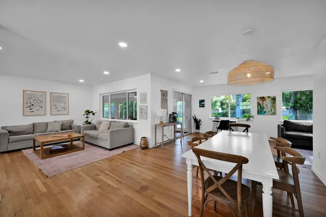 a living room with furniture a large window and a table