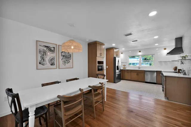 a large kitchen with a table and chairs