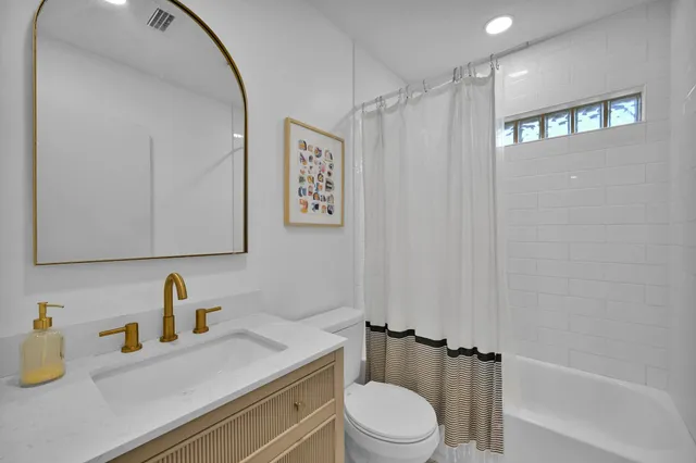 a bathroom with a sink a toilet and a shower