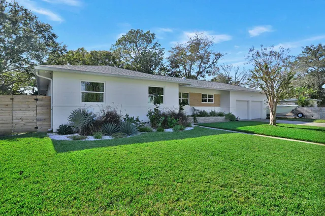 a front view of house with yard and green space