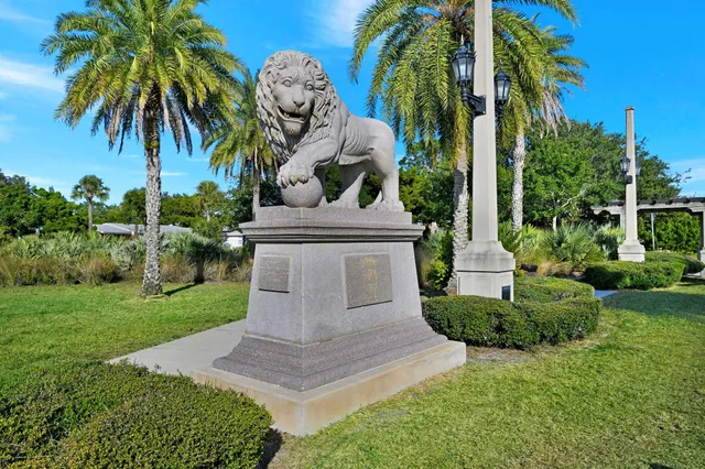 a view of a yard in front of a house with a garden