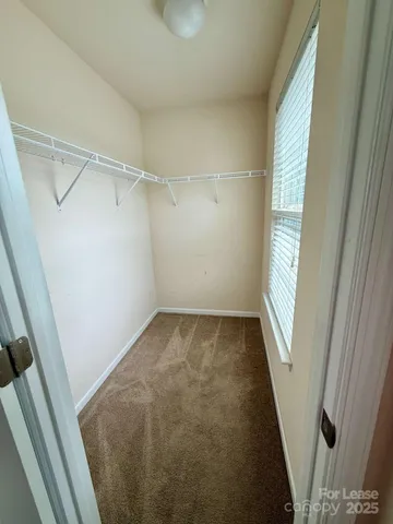 a bathroom with a double vanity sink a toilet and a mirror