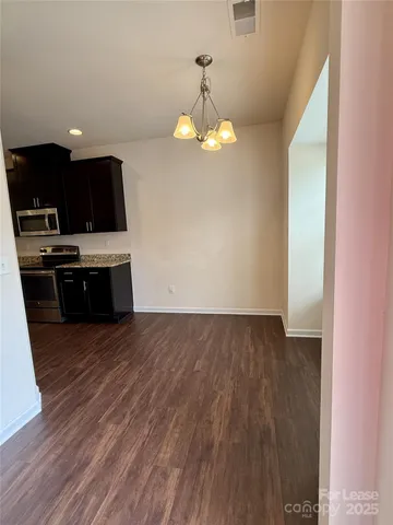 a view of kitchen with wooden floor and window