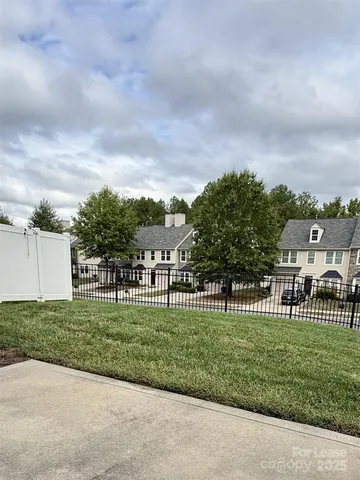 a view of a park with of a house in the background