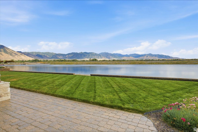 21 Pier Place Tooele, UT 84074 - Photo 100 of 112 Expansive outdoor patio with paver stones, a manicured lawn, and a waterfront setting