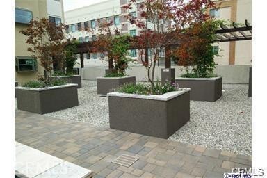 28 North 3rd Street, Unit B208 Alhambra, CA 91801 - Photo 25 of 27 a view of a house with fountain and a fire pit