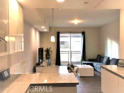 28 North 3rd Street, Unit B208 Alhambra, CA 91801 - Photo 8 of 27 a large room with a large window and furniture