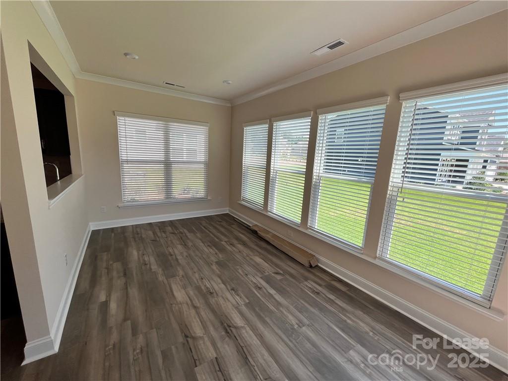 11506 Oakhampton Way Matthews, NC 28105 - Photo 13 of 27 a view of an empty room with wooden floor and a window