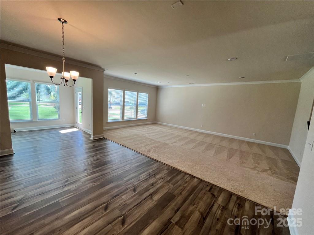 11506 Oakhampton Way Matthews, NC 28105 - Photo 15 of 27 a view of an empty room with wooden floor and a window