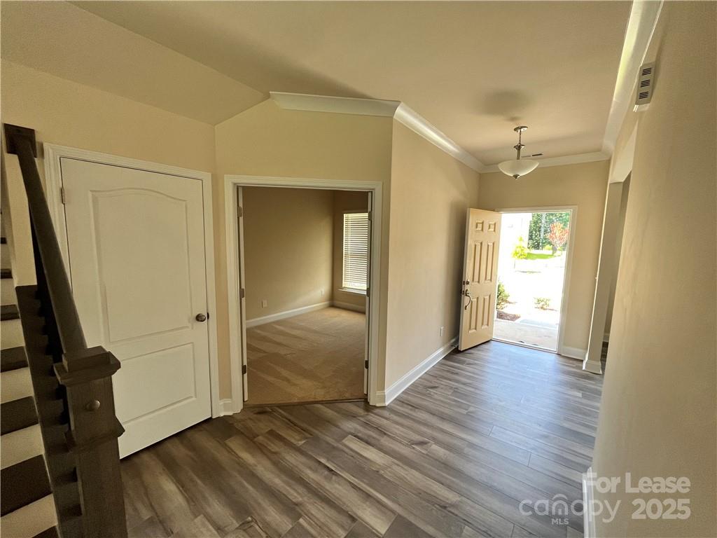 11506 Oakhampton Way Matthews, NC 28105 - Photo 5 of 27 a view of a hallway with wooden floor and closet area