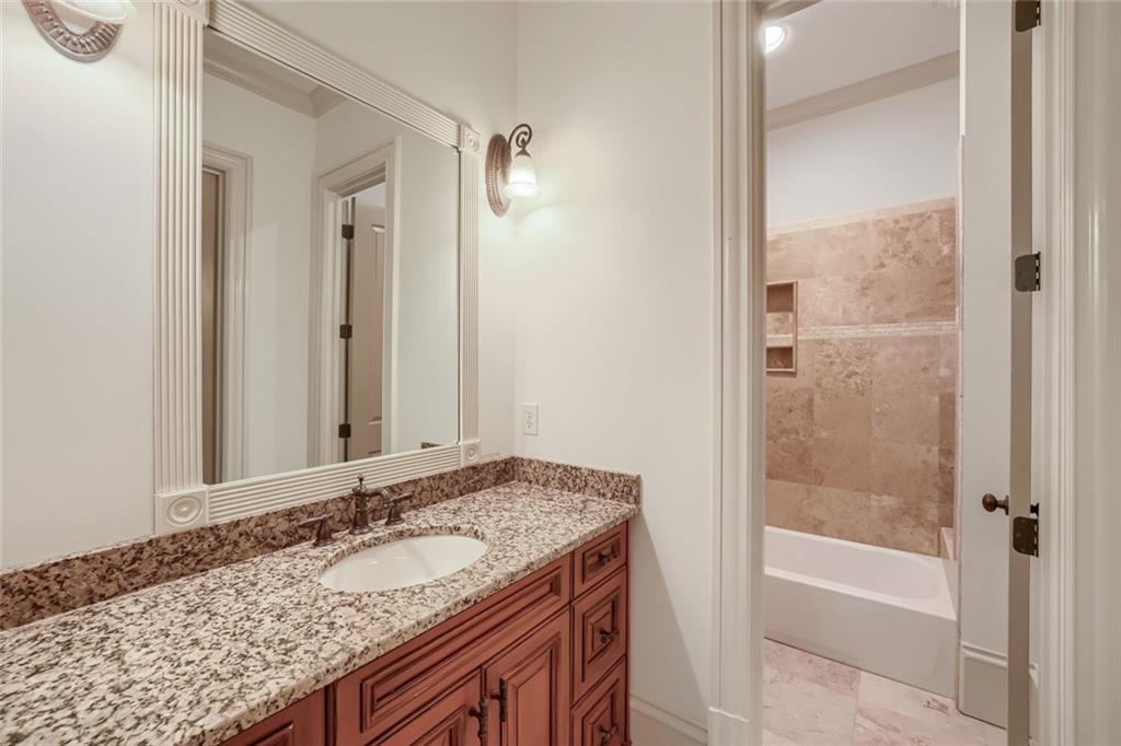 7965 Robin Road Cumming, GA 30041 - Photo 40 of 64 a bathroom with a granite countertop sink and a mirror