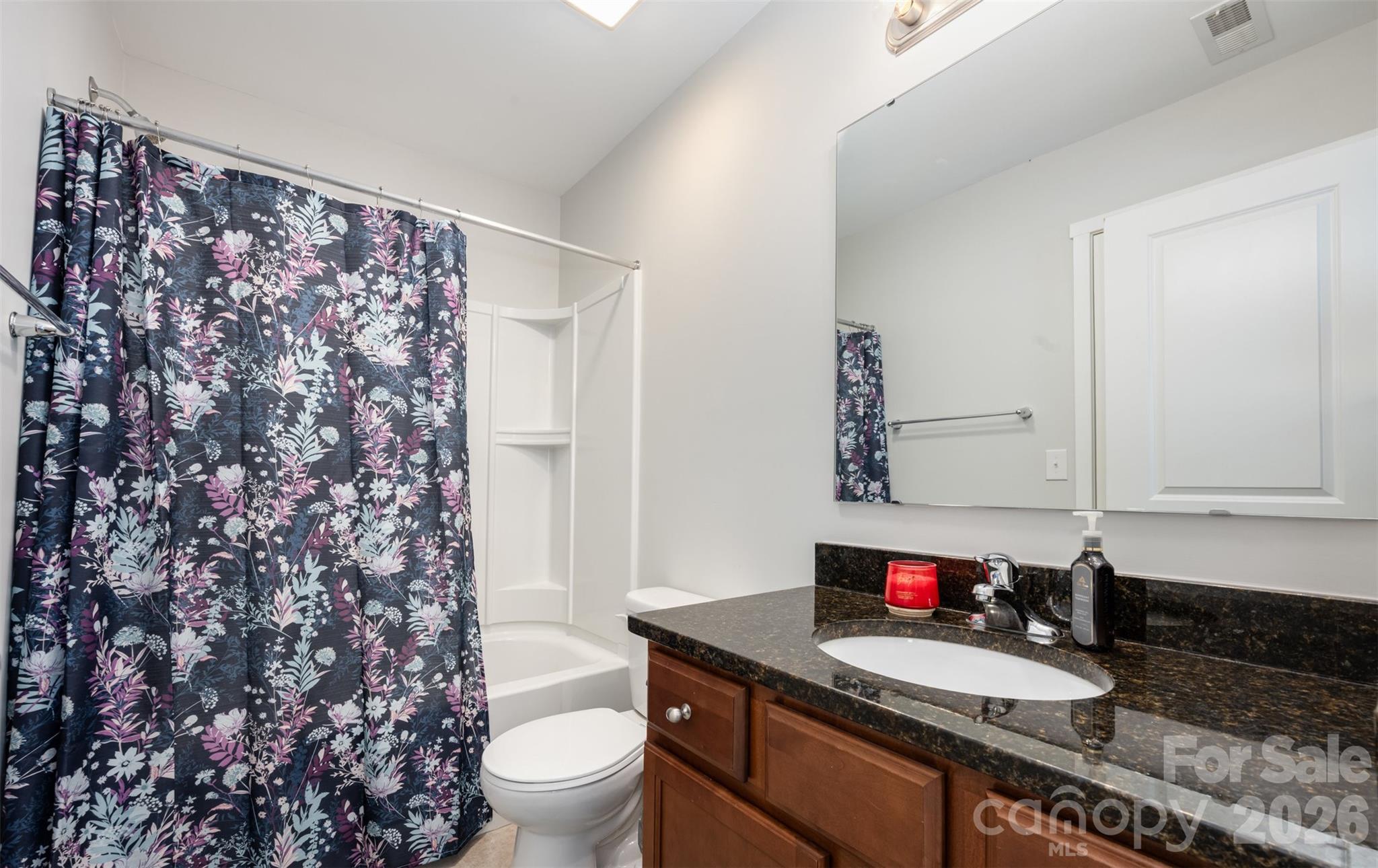 4822 Tradd Circle Monroe, NC 28110 - Photo 16 of 21 a bathroom with a granite countertop sink and a toilet