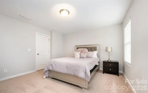 a bedroom with a bed and a night stand