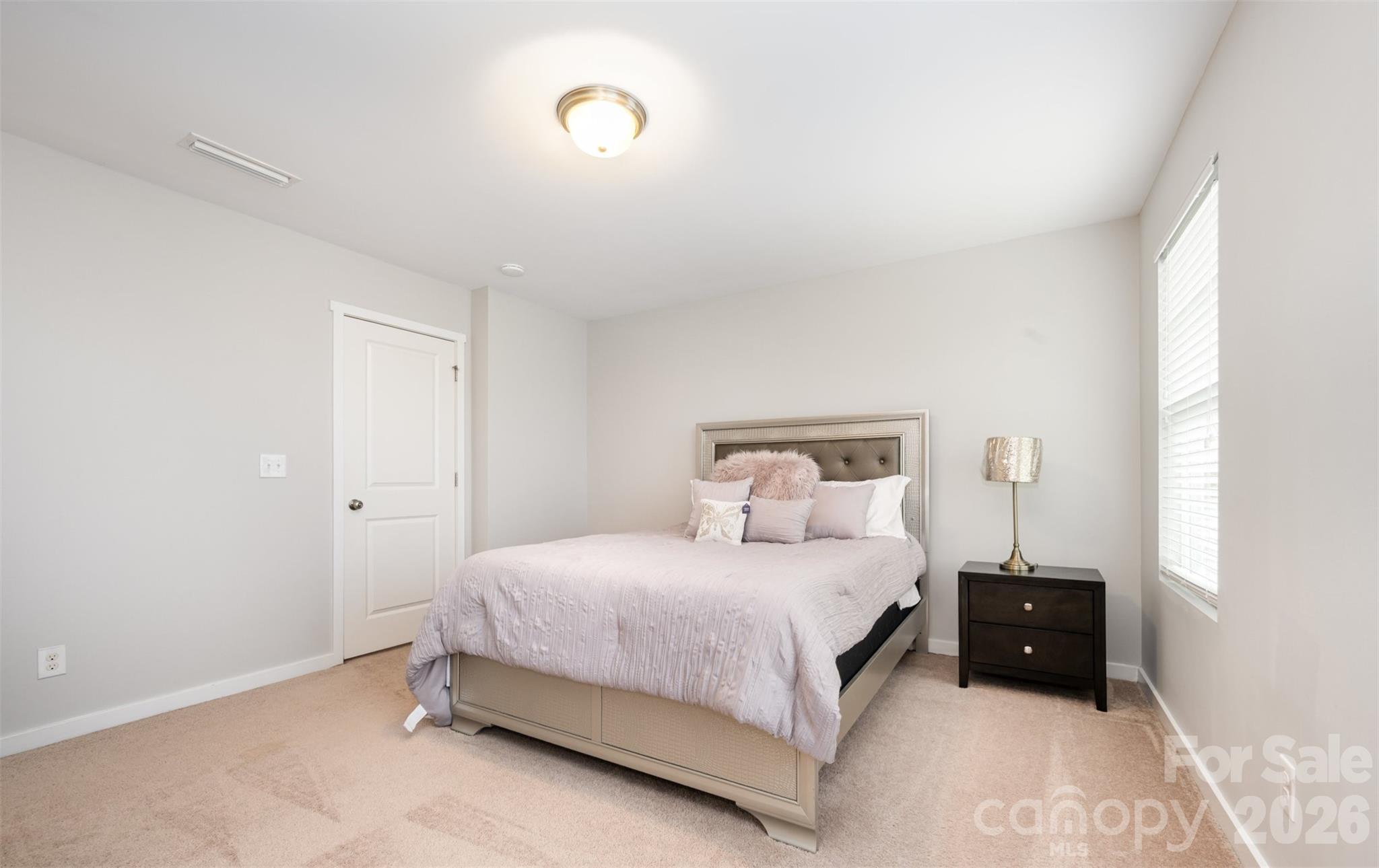 4822 Tradd Circle Monroe, NC 28110 - Photo 19 of 21 a bedroom with a bed and a night stand