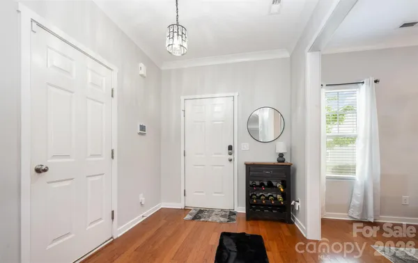 a room with wooden floor and white walls