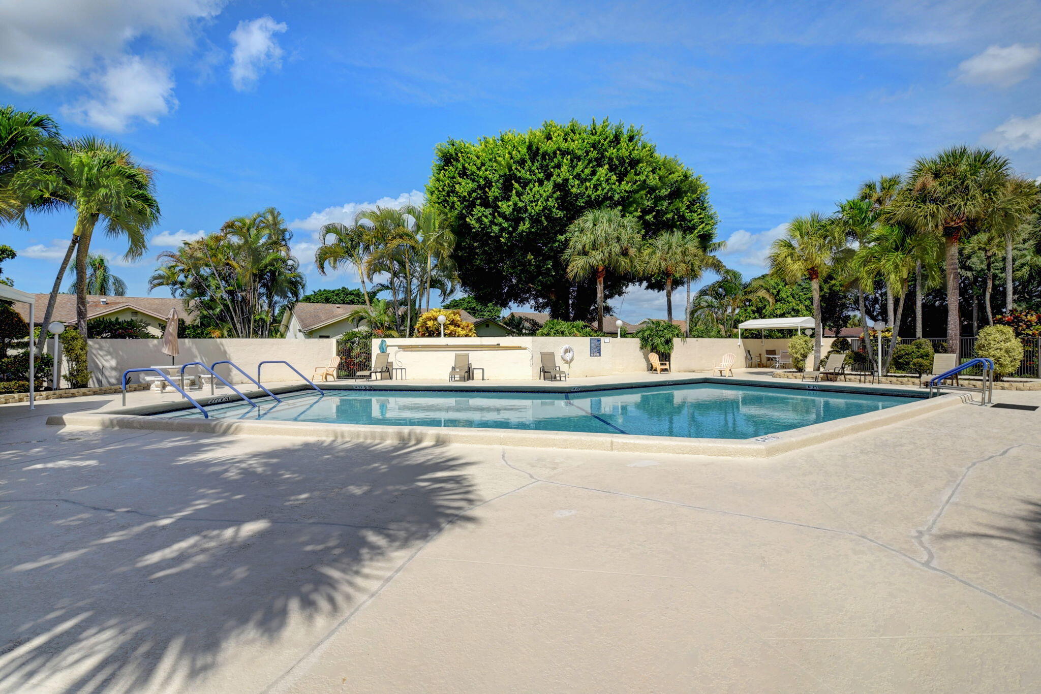 18093 104th Terrace South Boca Raton, FL 33498 - Photo 40 of 43 a view of a swimming pool with an outdoor space and seating area