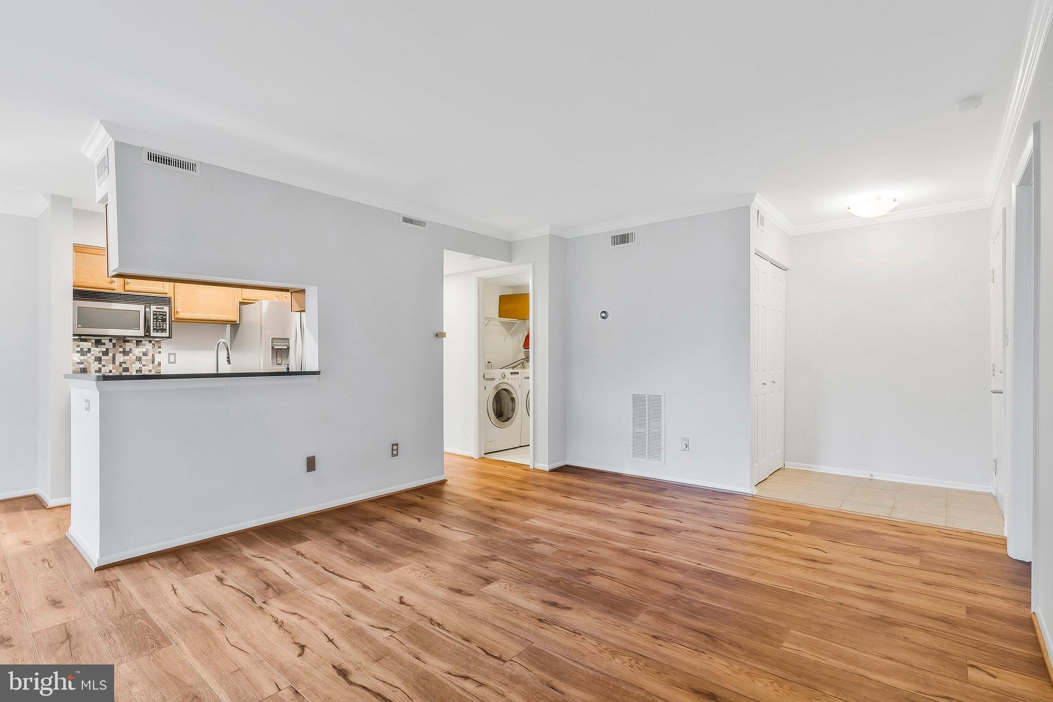 1701 Ascot Way, Unit 1701A Reston, VA 20190 - Photo 11 of 32 a view of an empty room with wooden floor