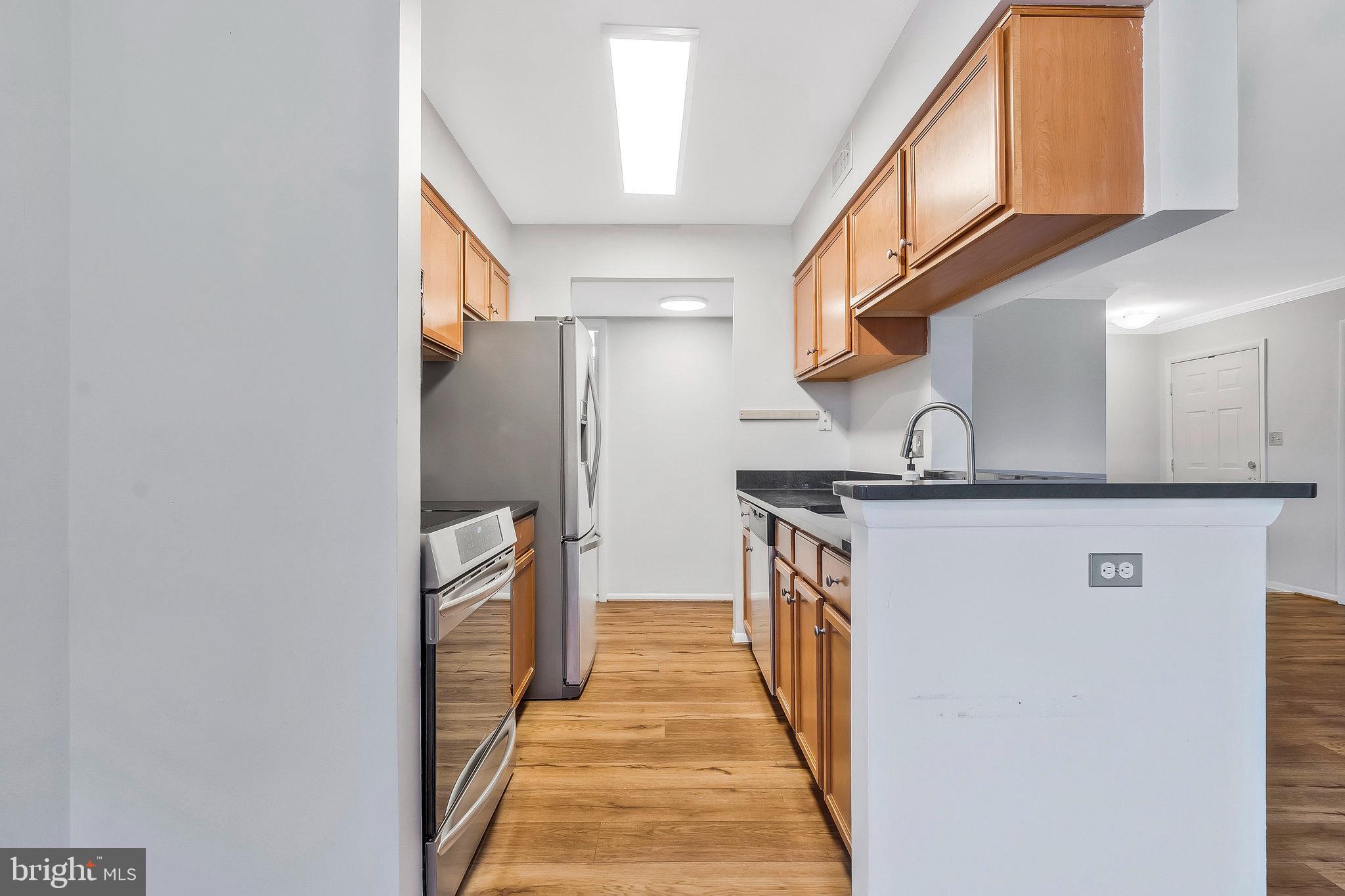 1701 Ascot Way, Unit 1701A Reston, VA 20190 - Photo 15 of 32 a kitchen with stainless steel appliances granite countertop a refrigerator and a stove