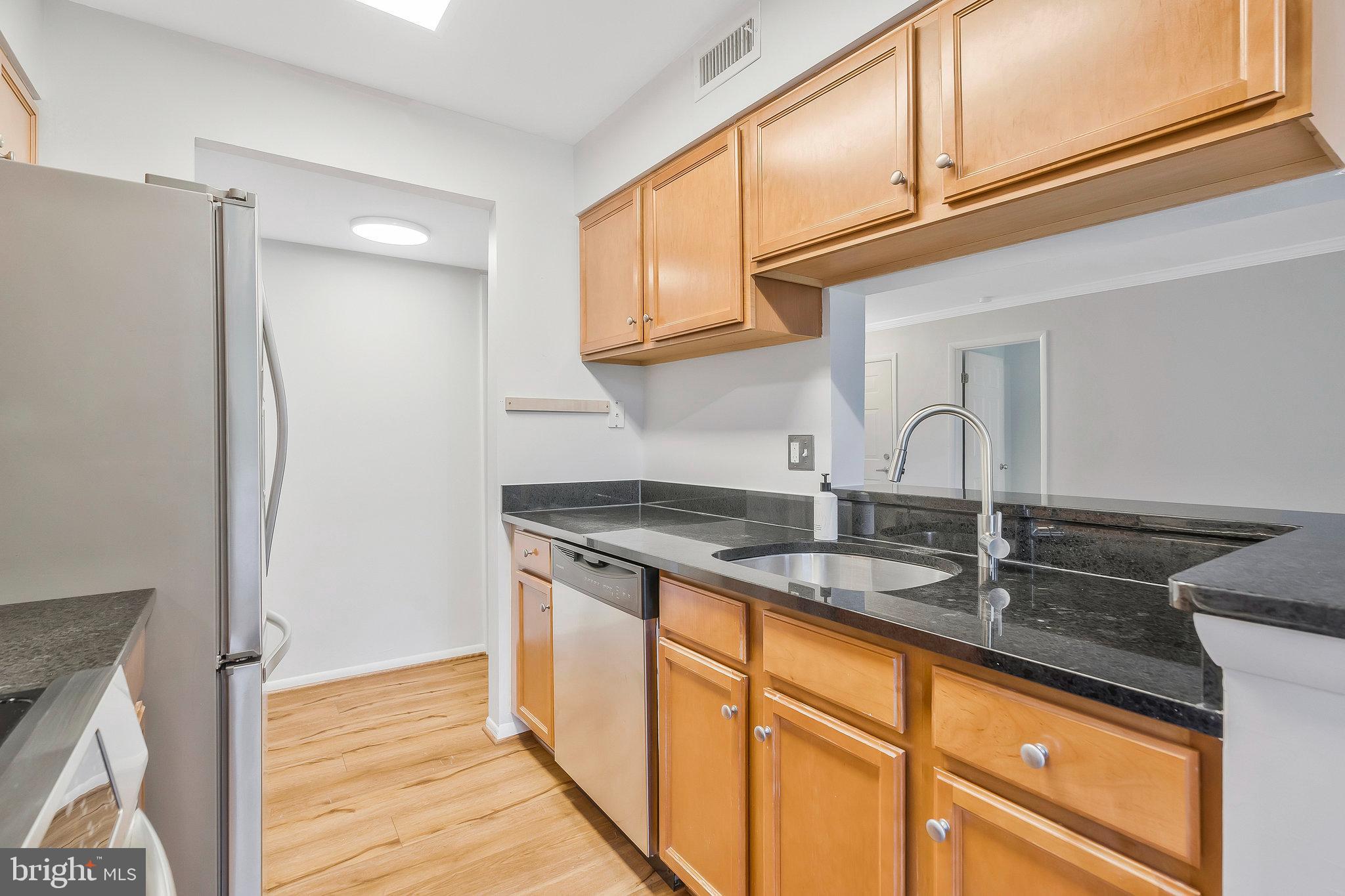 1701 Ascot Way, Unit 1701A Reston, VA 20190 - Photo 18 of 32 a kitchen with stainless steel appliances granite countertop a refrigerator and a sink