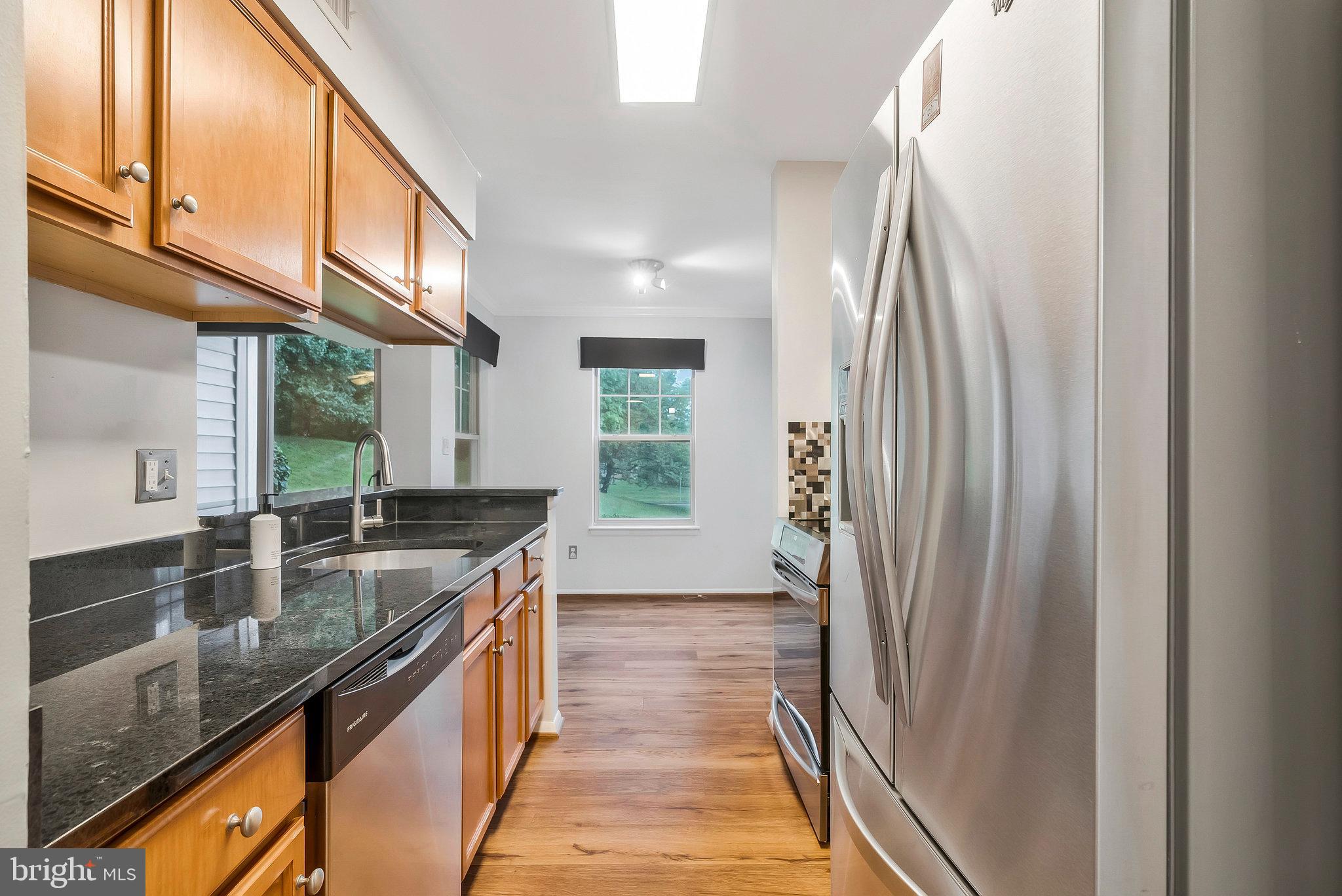1701 Ascot Way, Unit 1701A Reston, VA 20190 - Photo 20 of 32 a kitchen with sink a counter top space and cabinets