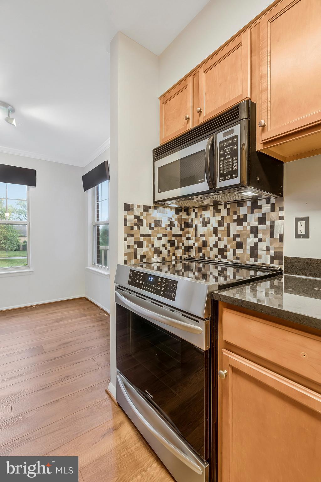 1701 Ascot Way, Unit 1701A Reston, VA 20190 - Photo 22 of 32 a kitchen with granite countertop a stove microwave and sink