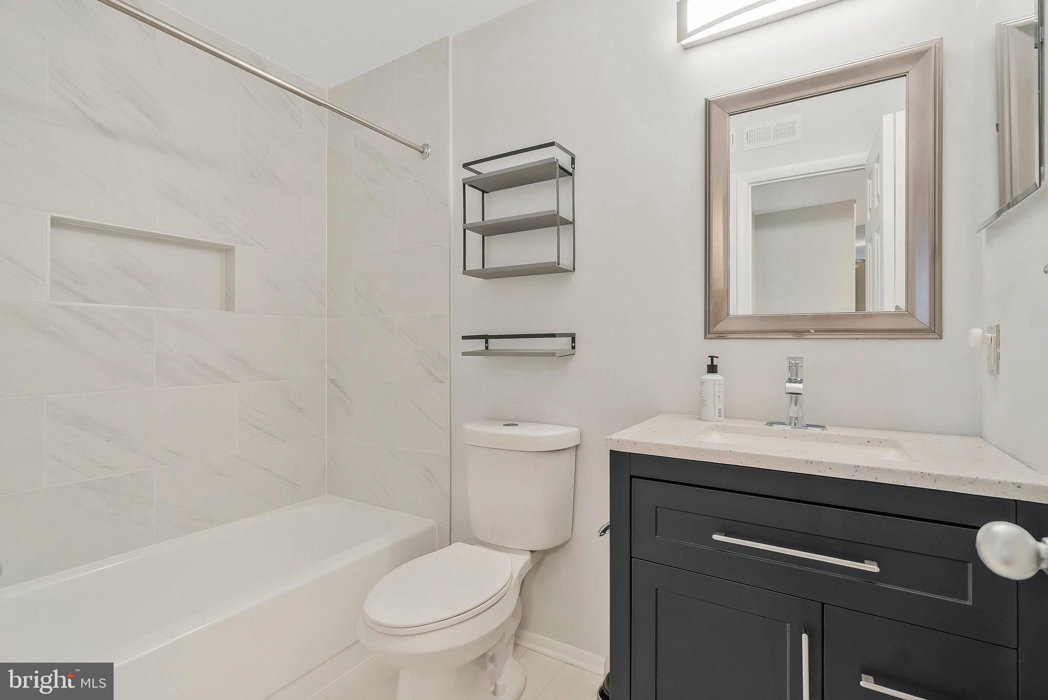 1701 Ascot Way, Unit 1701A Reston, VA 20190 - Photo 24 of 32 a bathroom with a toilet a sink a bath tub and mirror