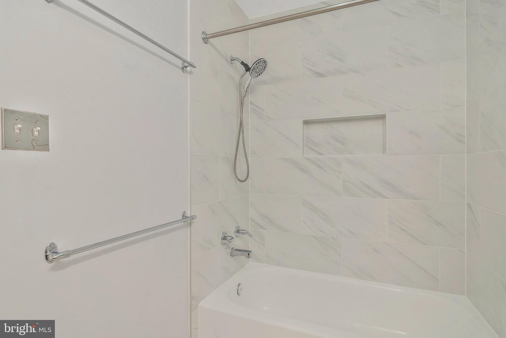 1701 Ascot Way, Unit 1701A Reston, VA 20190 - Photo 25 of 32 a bathroom with a bath tub with a shower