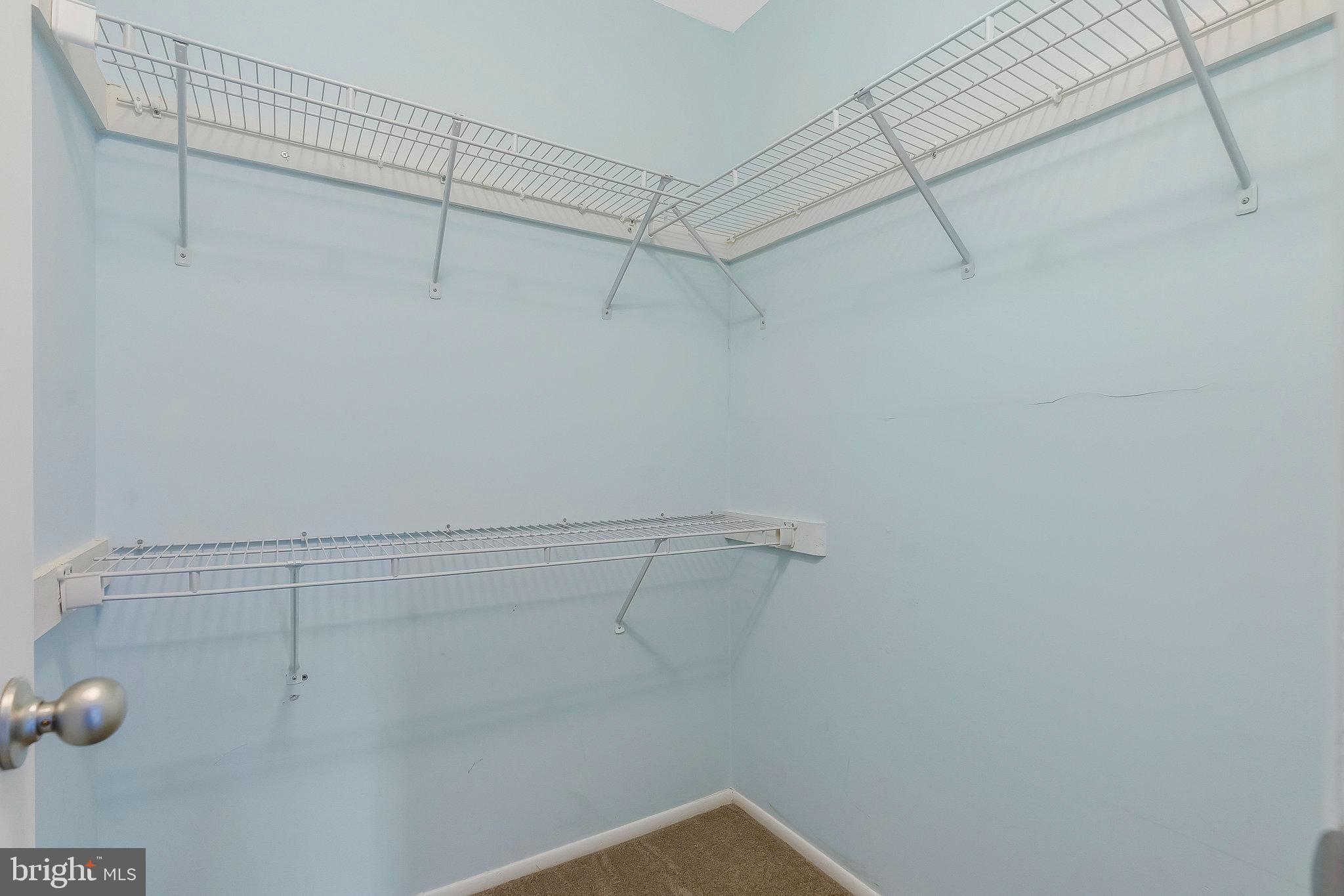 1701 Ascot Way, Unit 1701A Reston, VA 20190 - Photo 26 of 32 a view of a room with racks on the wall