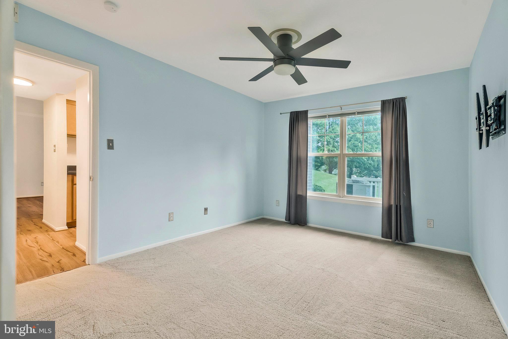 1701 Ascot Way, Unit 1701A Reston, VA 20190 - Photo 27 of 32 a view of a big room with wooden floor and windows