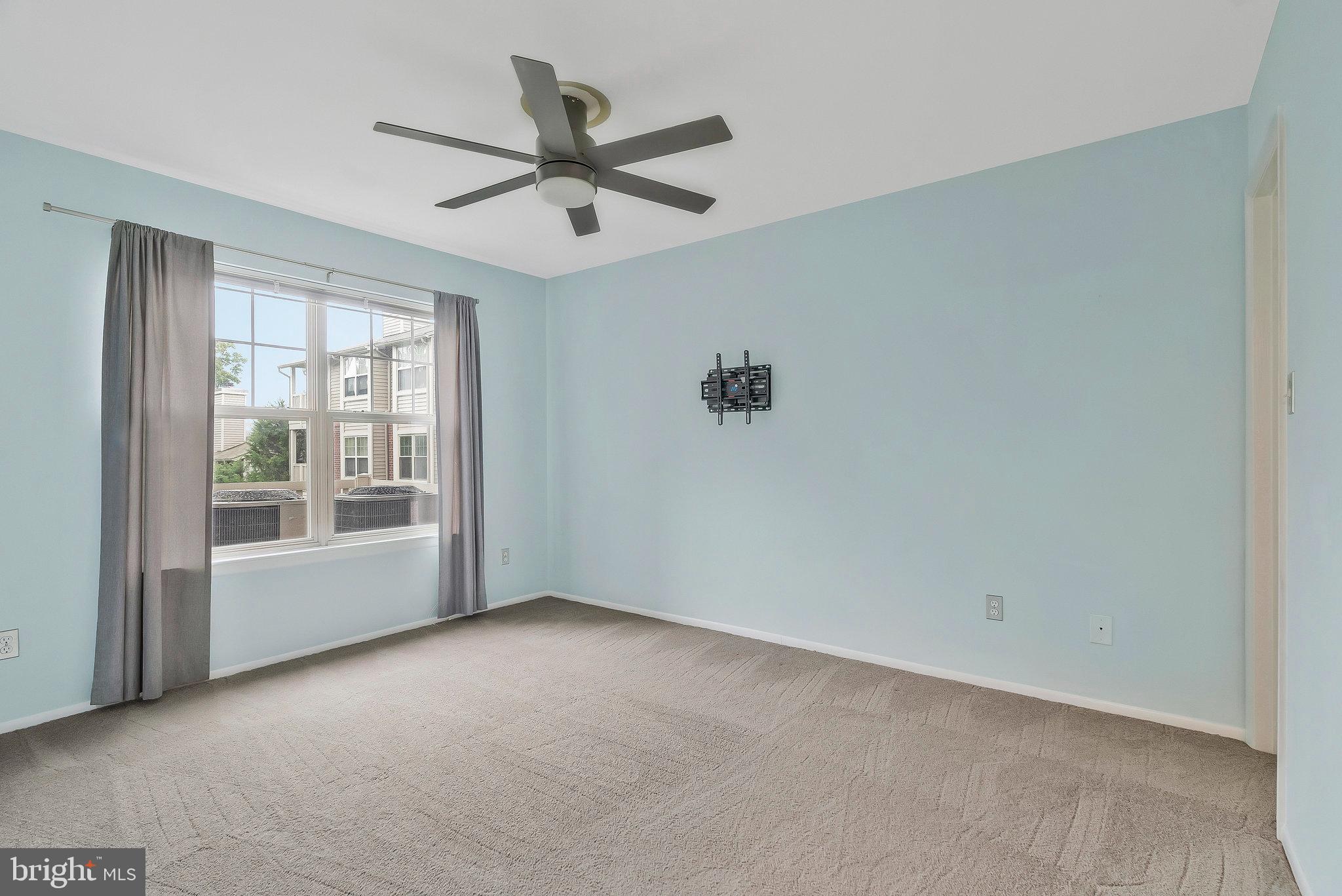1701 Ascot Way, Unit 1701A Reston, VA 20190 - Photo 29 of 32 a view of a livingroom with a ceiling fan and window
