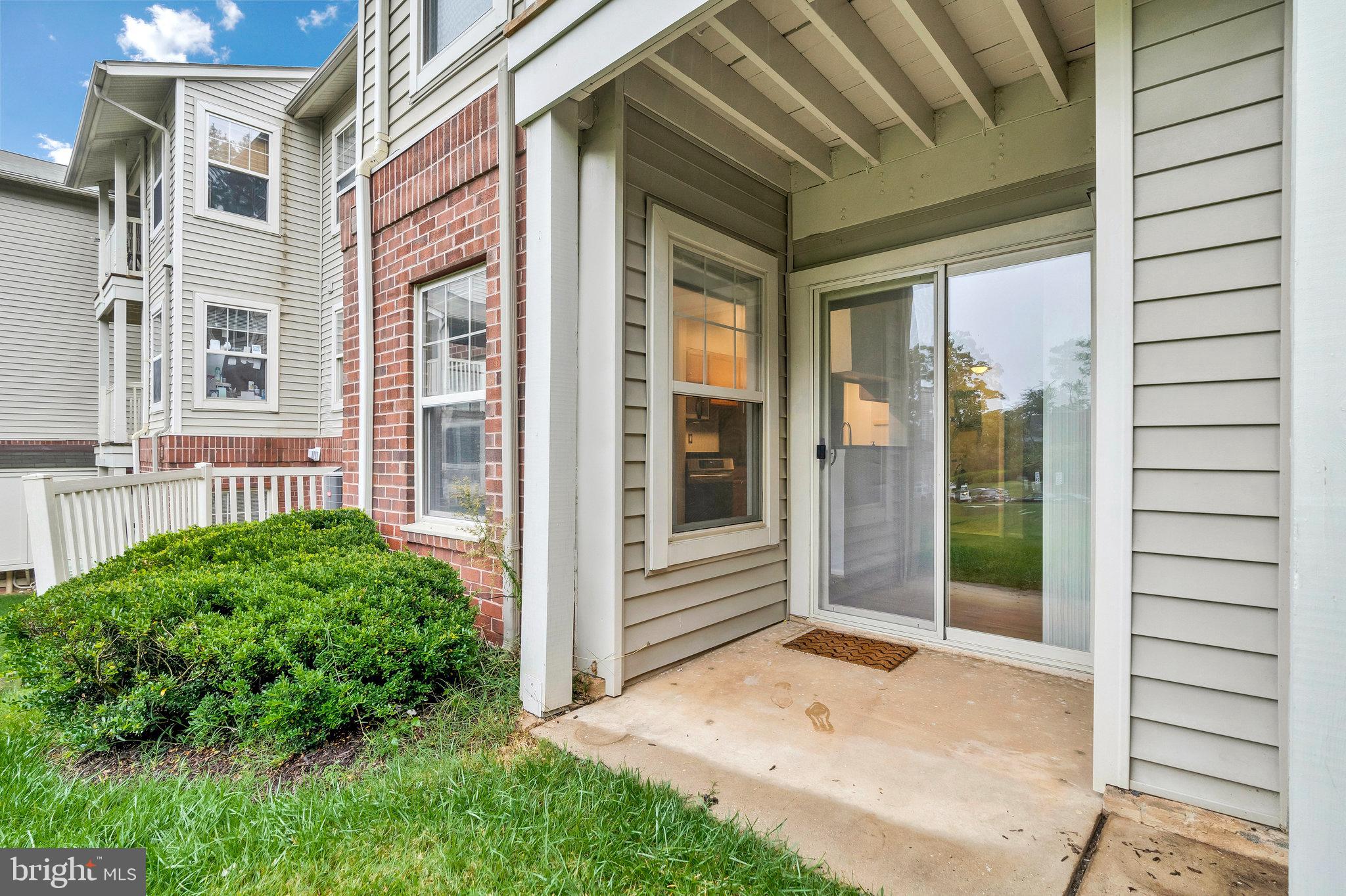 1701 Ascot Way, Unit 1701A Reston, VA 20190 - Photo 3 of 32 a view of yellow house with a large windows