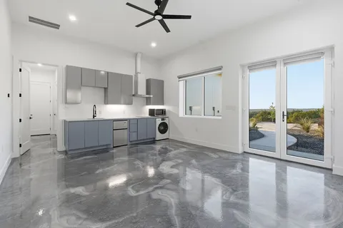 a view of a kitchen with furniture and a ceiling fan