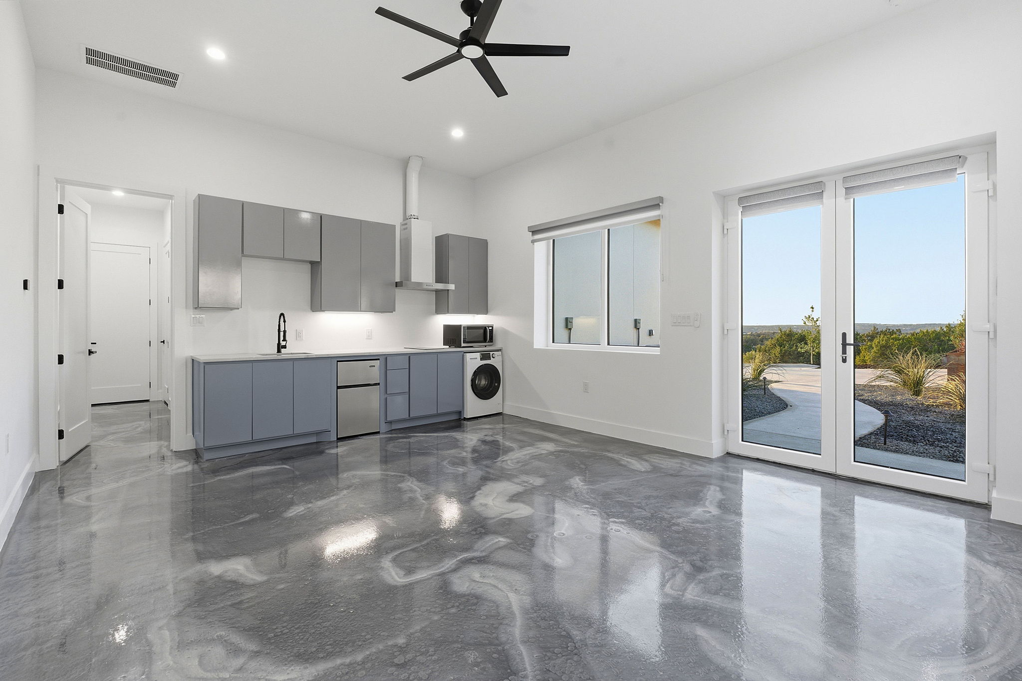 15400 Watumba Road Austin, TX 78734 - Photo 29 of 39 a view of a kitchen with furniture and a ceiling fan