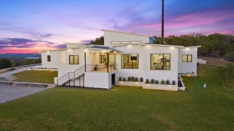 a front view of a house with a yard and outdoor seating
