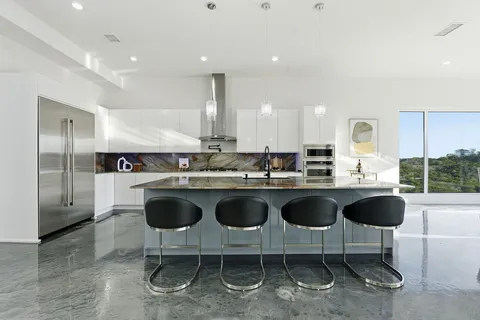 a kitchen with a sink cabinets and window