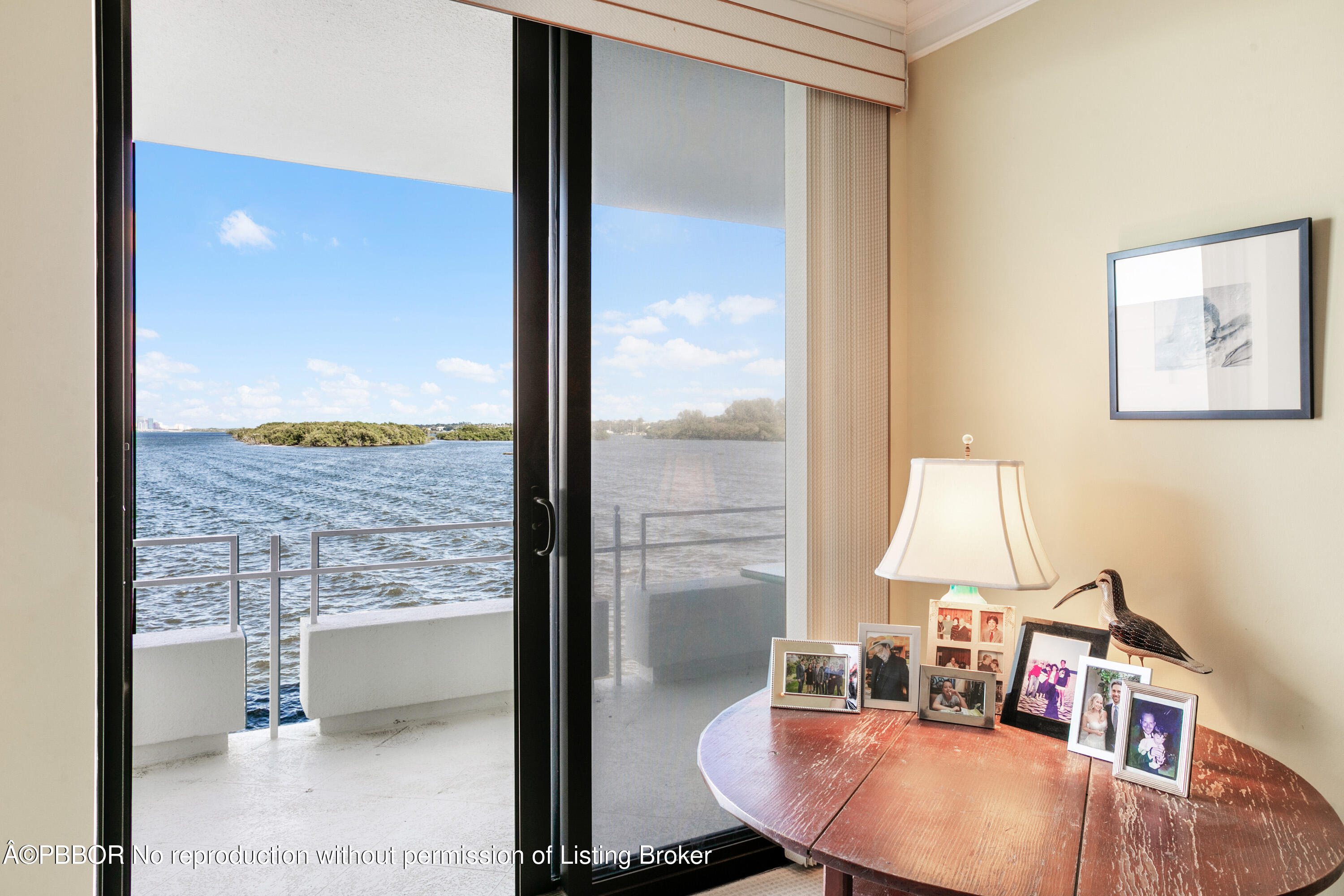 2150 Ibis Isle Road, Unit 7 Palm Beach, FL 33480 - Photo 12 of 49 a view of a living room with a floor to ceiling window and wooden floor