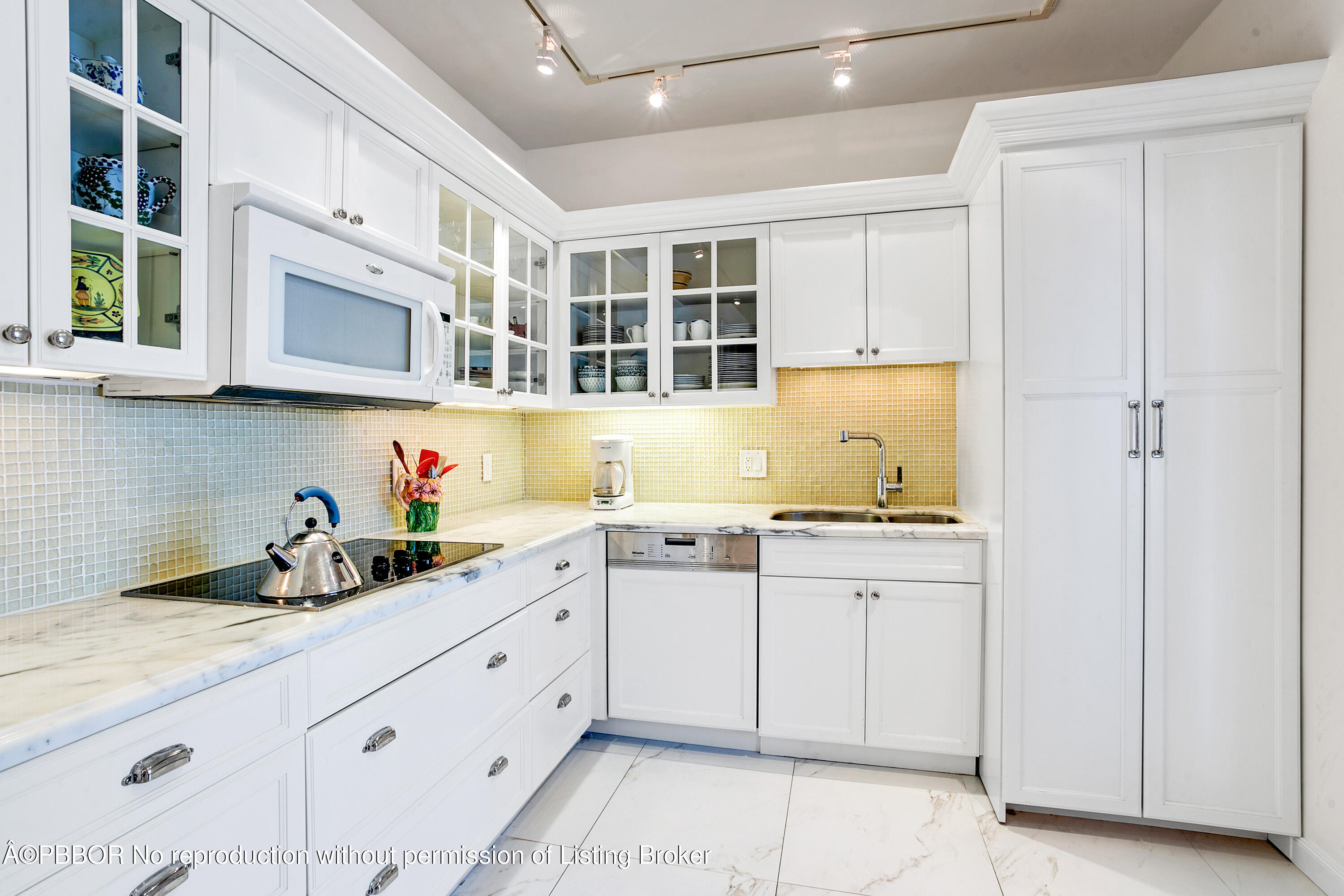 2150 Ibis Isle Road, Unit 7 Palm Beach, FL 33480 - Photo 17 of 49 a kitchen with stainless steel appliances granite countertop a sink and cabinets