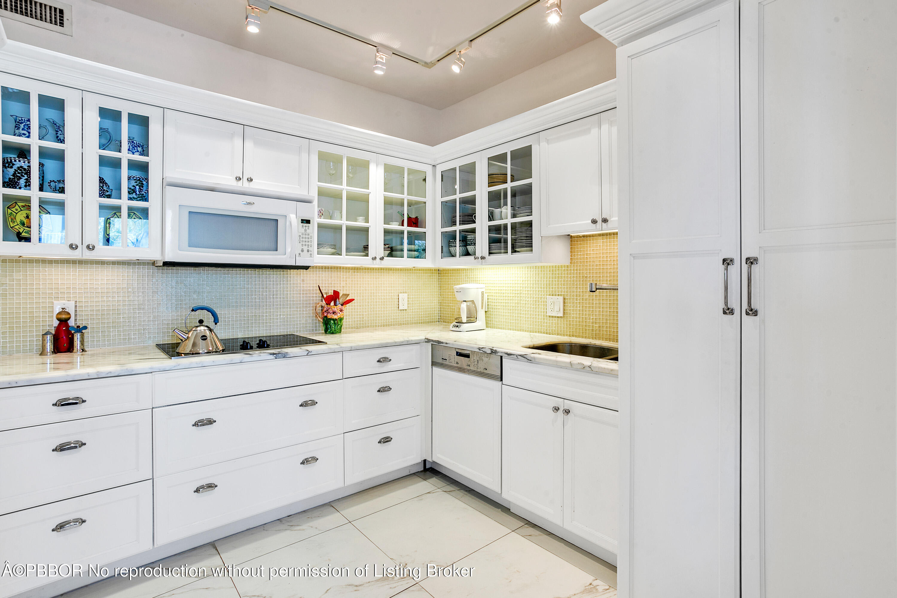 2150 Ibis Isle Road, Unit 7 Palm Beach, FL 33480 - Photo 18 of 49 a kitchen with granite countertop white cabinets and sink