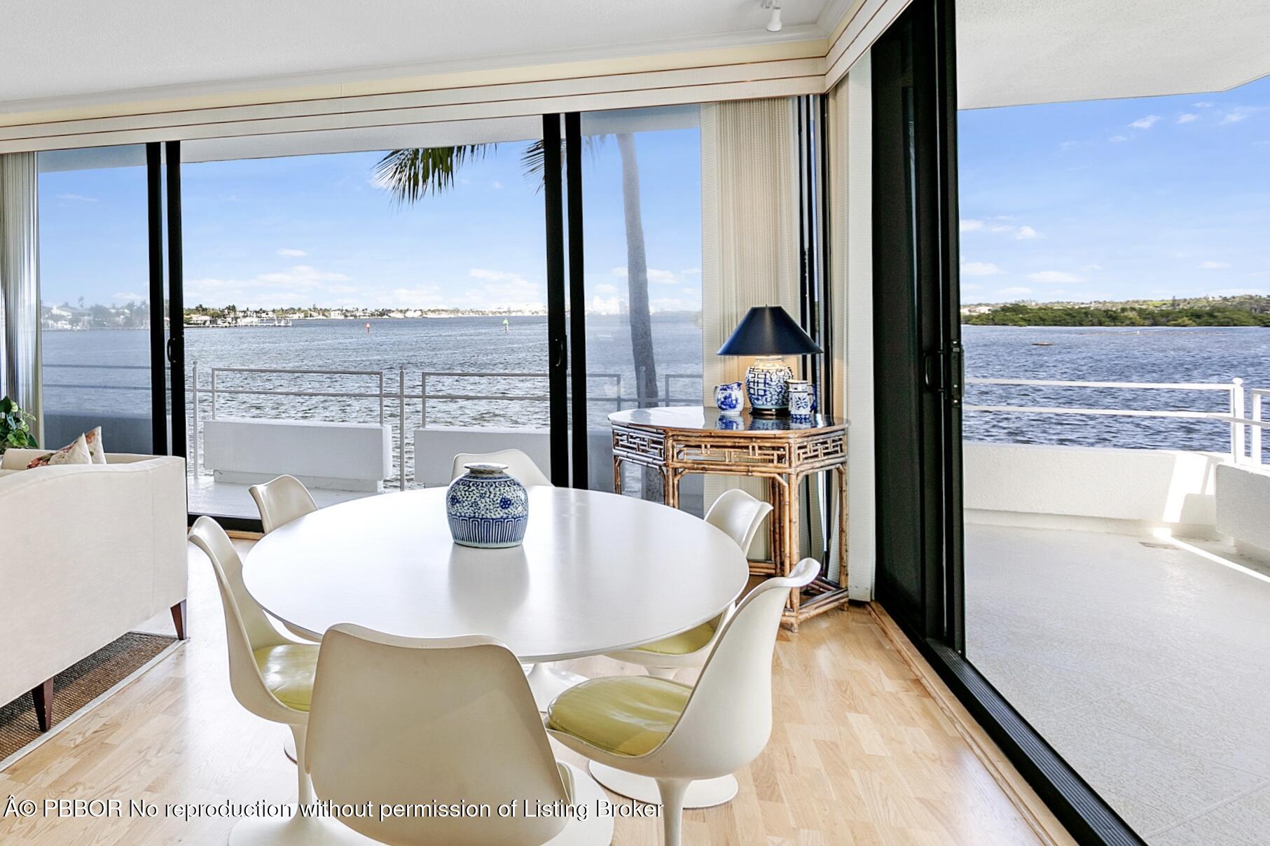 2150 Ibis Isle Road, Unit 7 Palm Beach, FL 33480 - Photo 3 of 49 a dining room with furniture and a floor to ceiling window