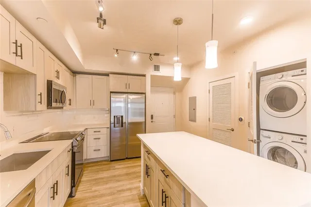 a kitchen with a sink a stove and refrigerator