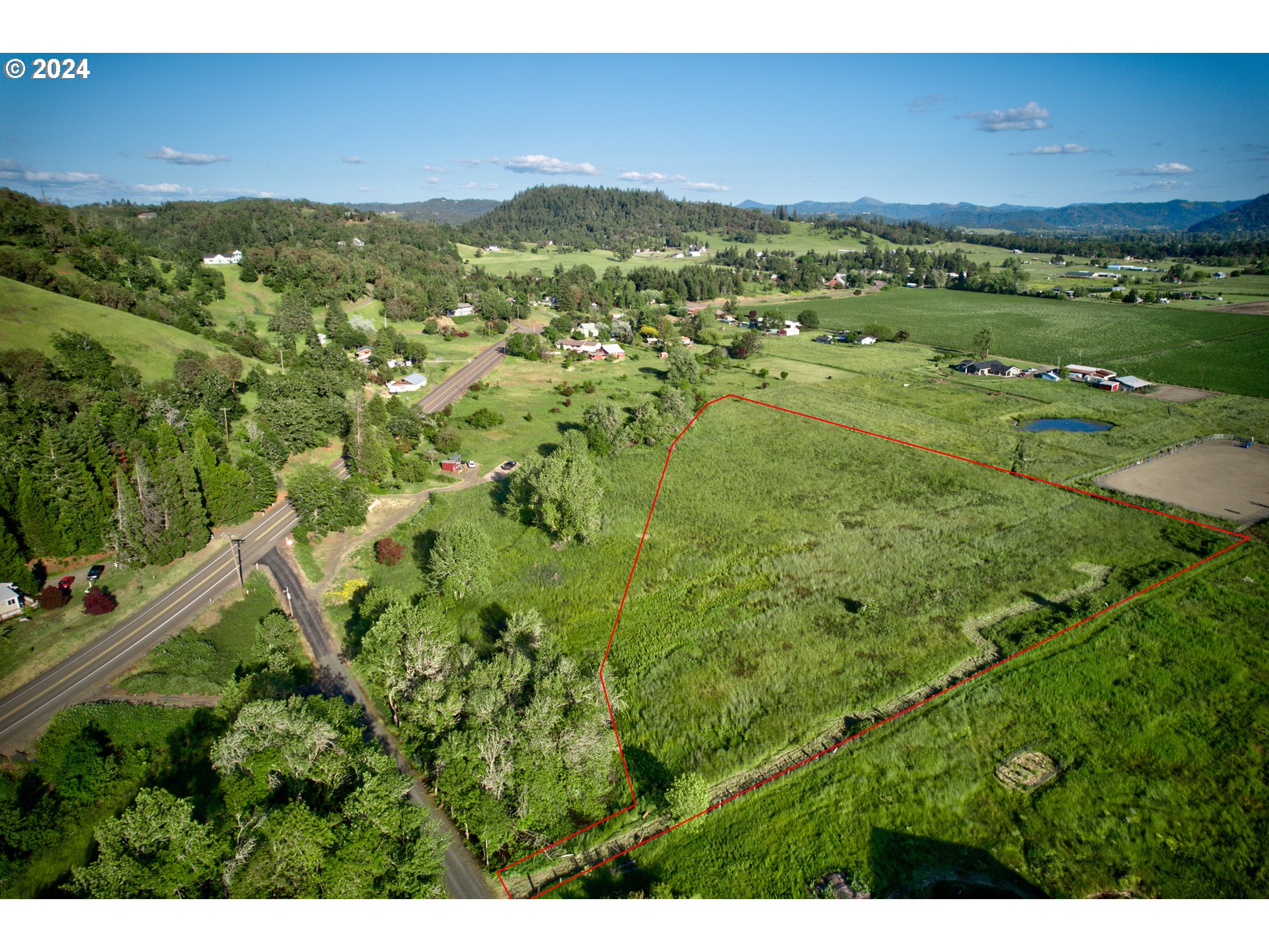 a view of a green field with an outdoor space