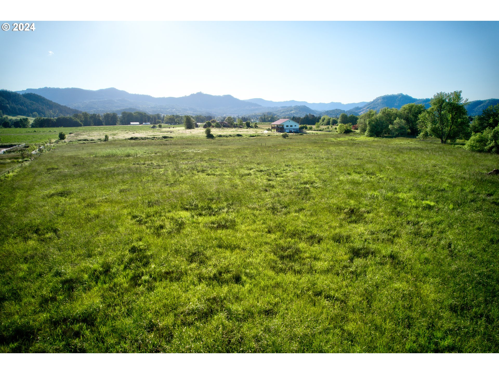 0 Healy Road, Unit 402 Roseburg, OR 97471 - Photo 18 of 24 a view of a lush green hillside and a houses