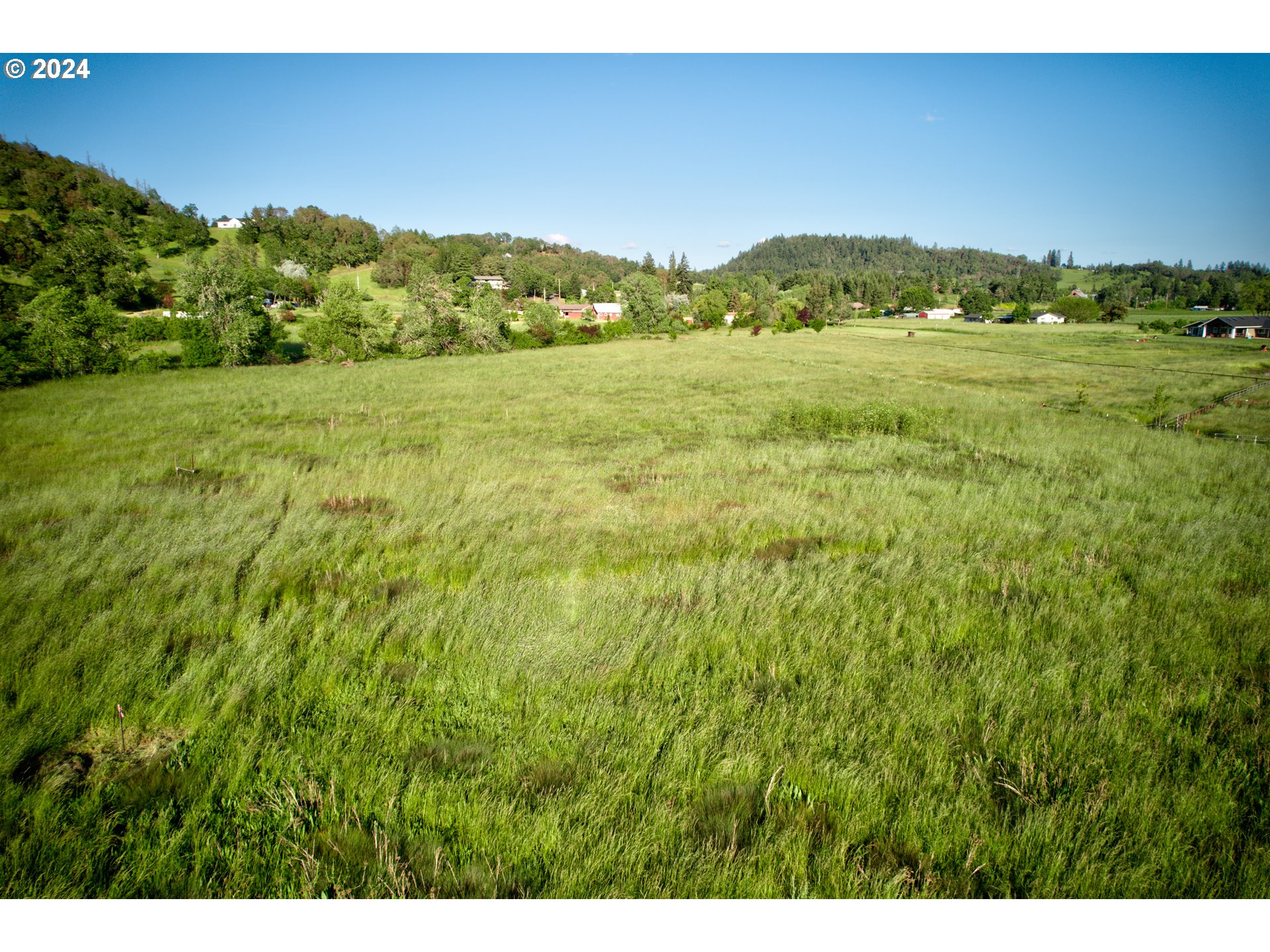 0 Healy Road, Unit 402 Roseburg, OR 97471 - Photo 20 of 24 a view of a lush green hillside and a houses