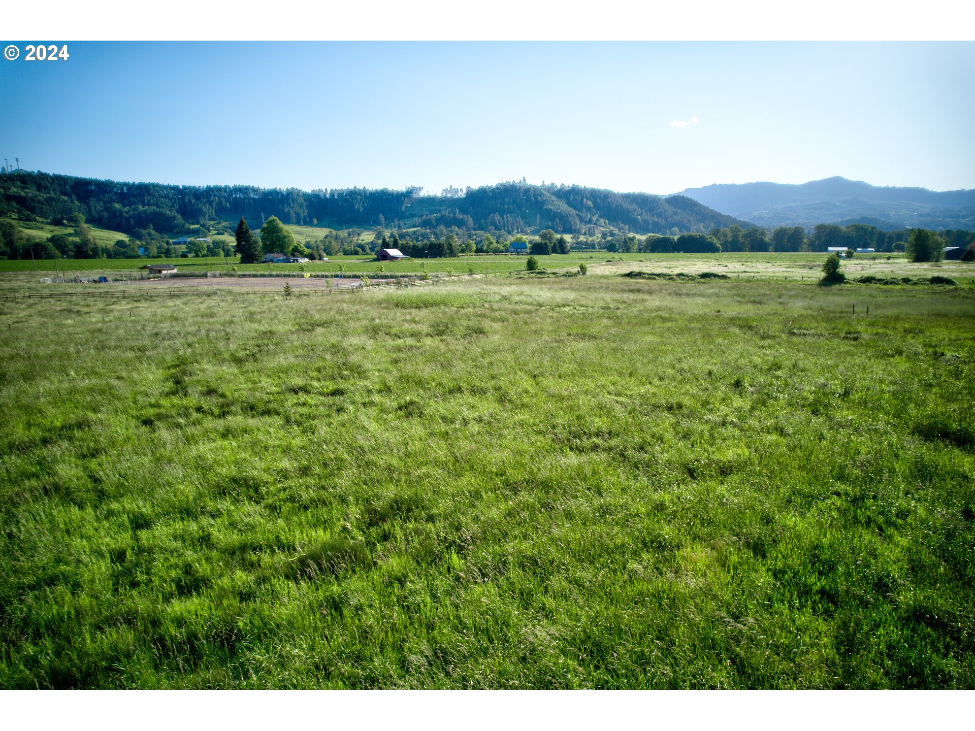 0 Healy Road, Unit 402 Roseburg, OR 97471 - Photo 21 of 24 a view of a lush green hillside and a houses