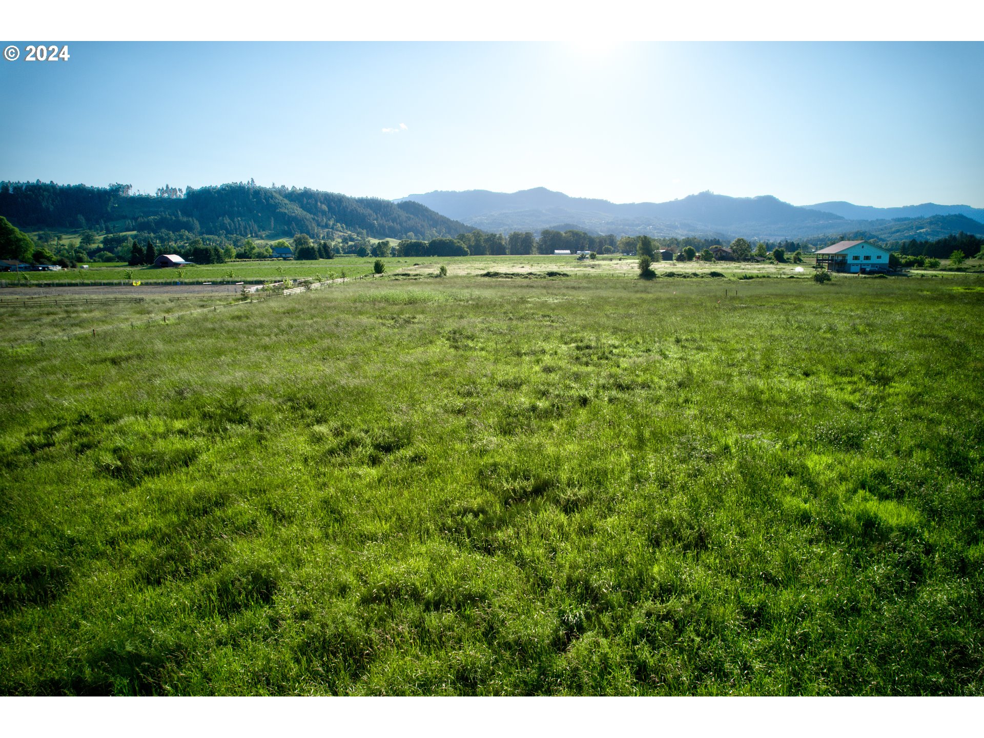 0 Healy Road, Unit 402 Roseburg, OR 97471 - Photo 22 of 24 a view of a lush green hillside and a houses