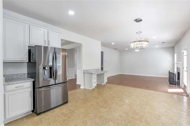 a kitchen with stainless steel appliances granite countertop a refrigerator a sink and a stove