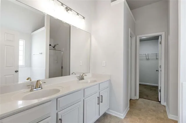 a bathroom with double sink and a mirror