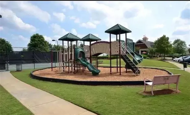 a balcony with wooden floor and trees in the back